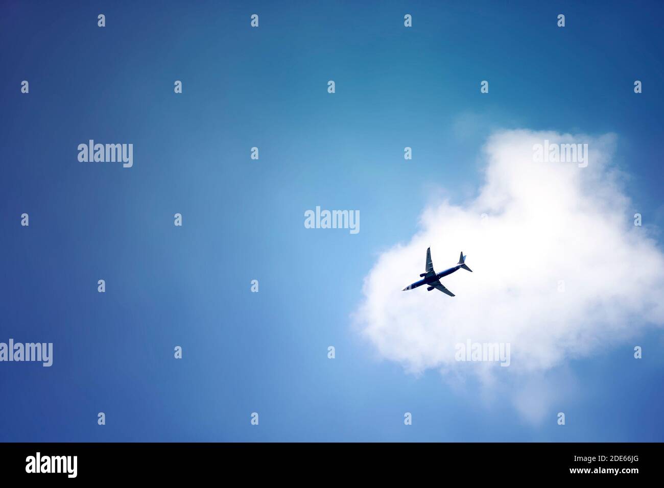 Ein Flugzeug, das den blauen Himmel überquert Stockfoto