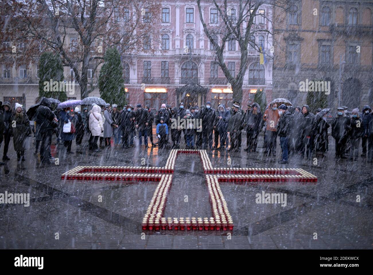Non Exclusive: LVIV, UKRAINE - 28. NOVEMBER 2020 - die Menschen stehen vor einem Kreuz aus Mahnlaternen, während sie den Opfern der 1932-1 Tribut zollen Stockfoto