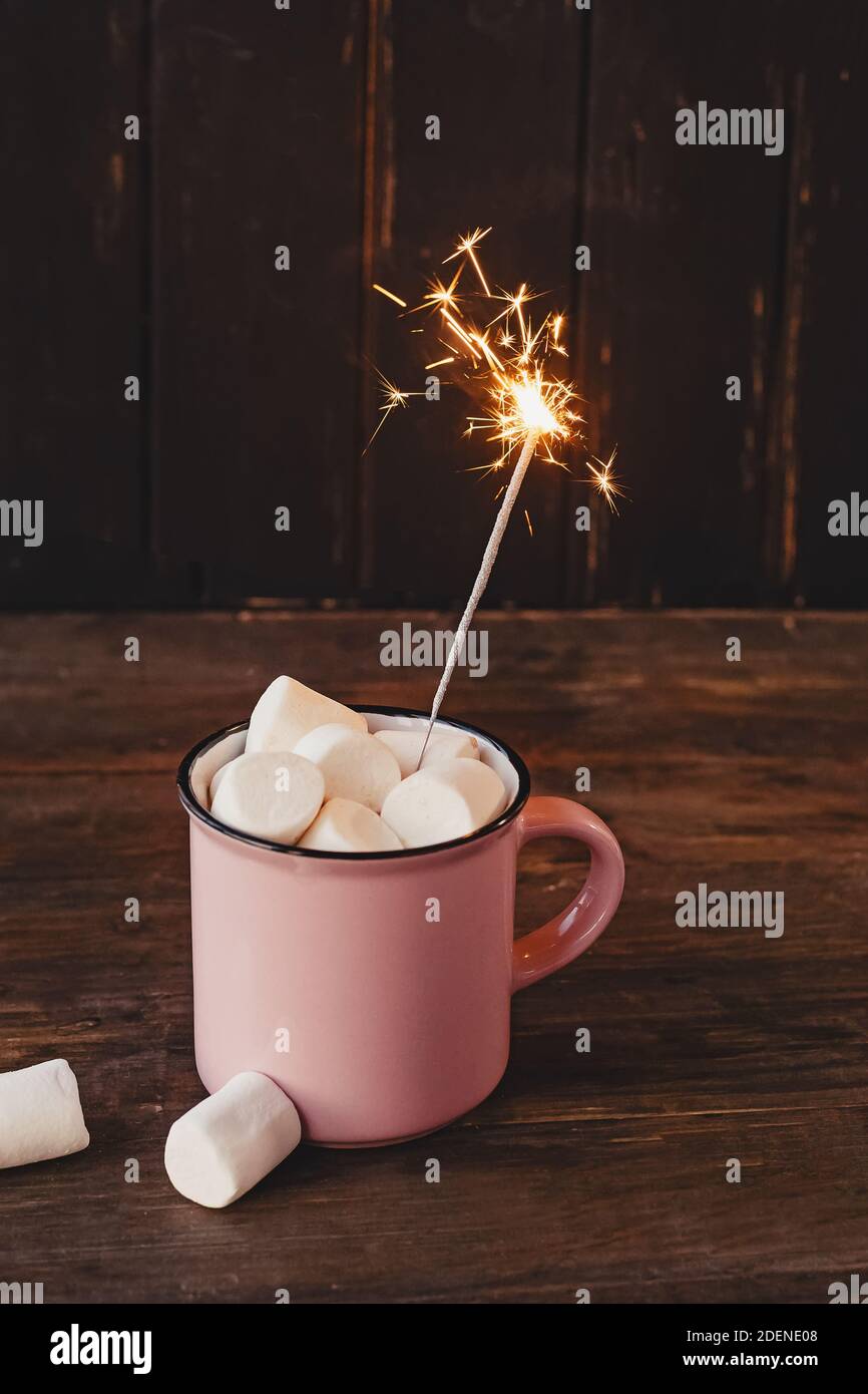 Tasse heiße Schokolade oder Kakao mit Marshmallows mit brennendem Sparkler. Winterurlaub Getränk. Stockfoto