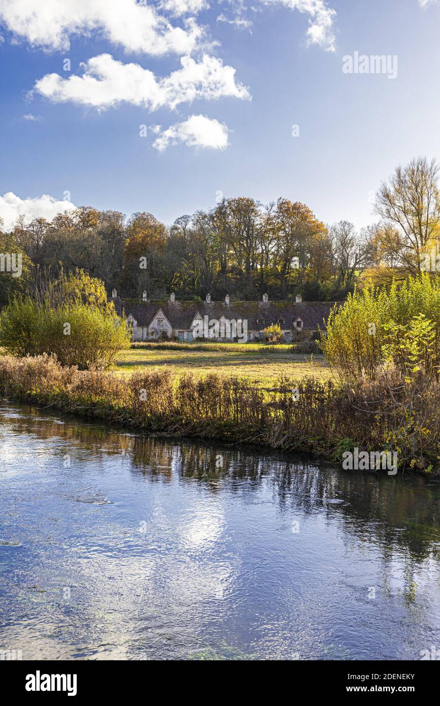 Herbst in den Cotswolds - The River Coln, Rack Isle und Arlington Row im Dorf Bibury, Gloucestershire UK Stockfoto
