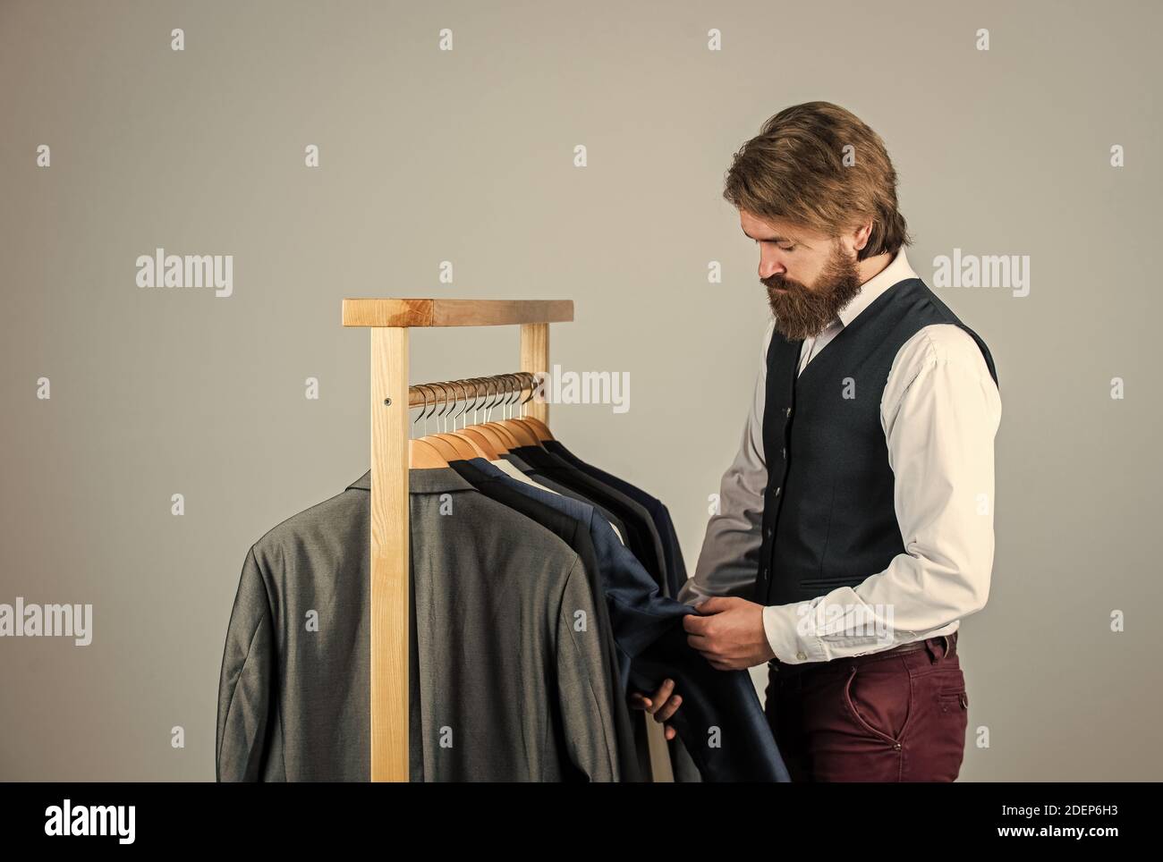 Entwicklung einer neuen Modelinie. Individuelle Maßnahmen Hand des Menschen. Mann bestellt Business Anzug posiert drinnen. Tailor Maßnahmen Mann. Stilvolle Mann am Arbeitsplatz. Stockfoto