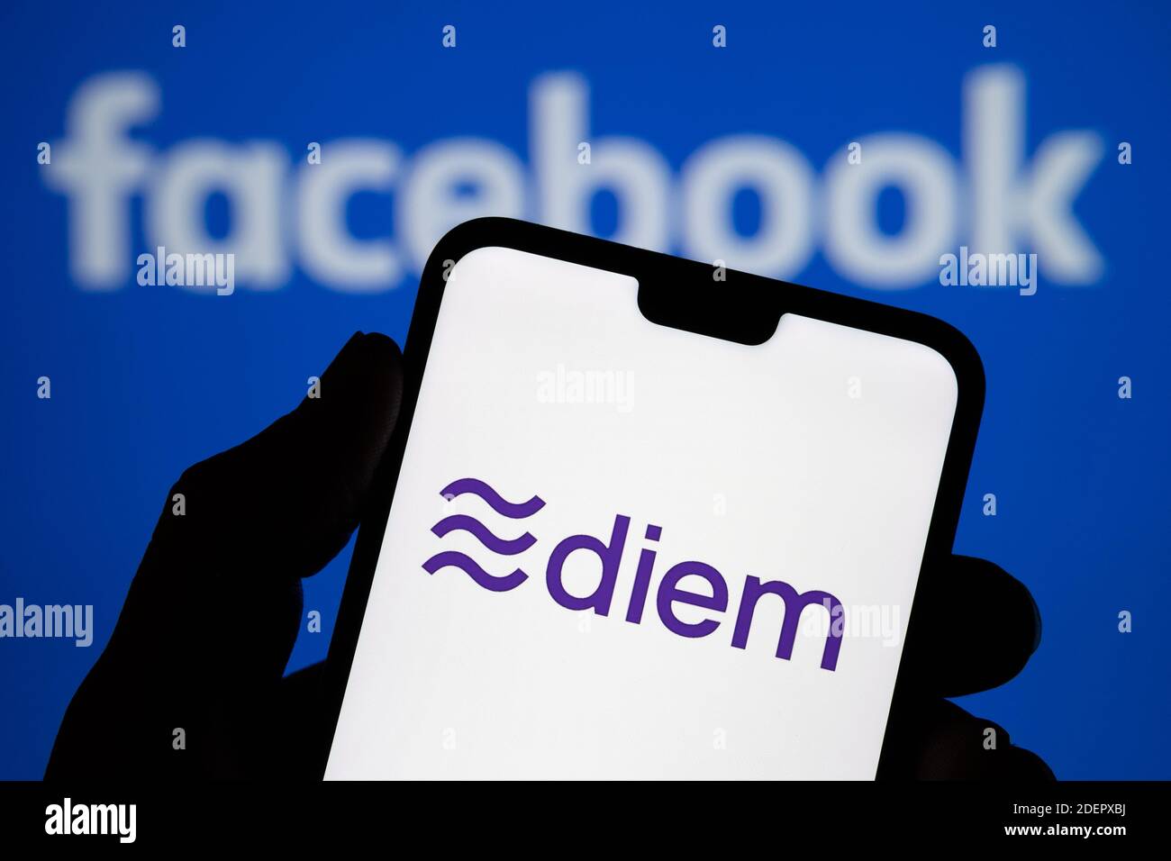 Stafford, Vereinigtes Königreich - 1. Dezember 2020: Diem Währung Logo auf dem Smartphone Silhouette und verschwommen Facebook-Logo auf dem Hintergrund. Diem ist rebra Stockfoto