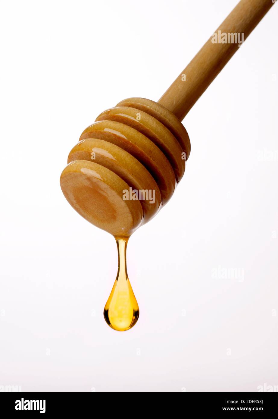 Hölzerner Honigtropfstab Stockfoto