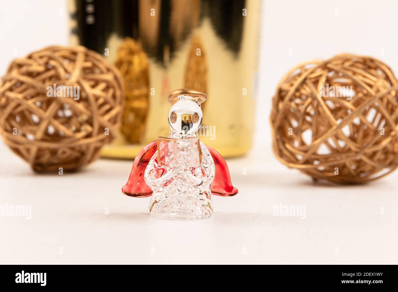 Souvenir Kristallengel, goldene Kugeln und Champagner-Geschenkflasche auf weißem Holztisch Stockfoto
