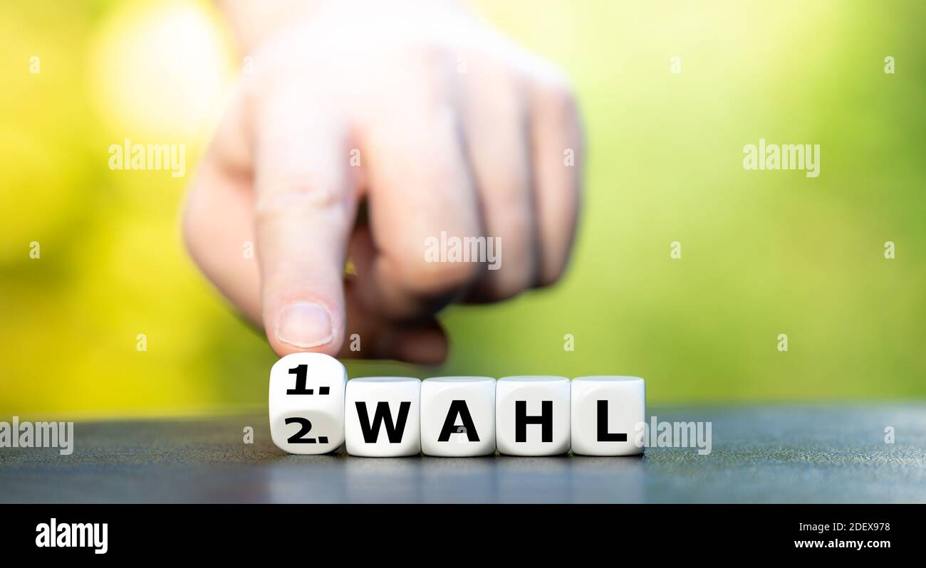 Hand dreht Würfel und ändert den deutschen Ausdruck '2. Wahl' (zweite Wahl) bis '1. Wahl' (erste Wahl). Stockfoto