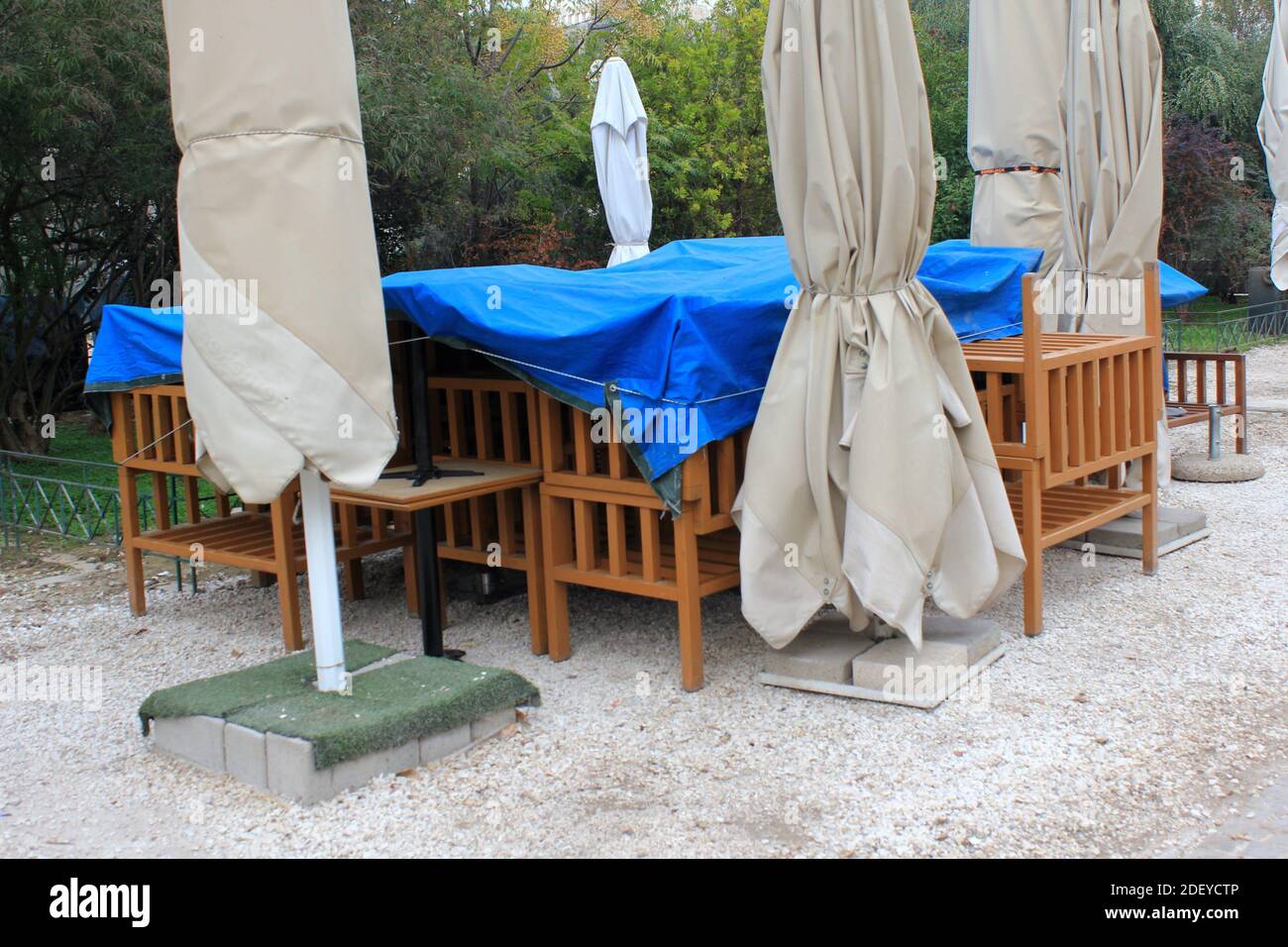 Stühle, Tische und andere Möbel außerhalb gestapelt geschlossenes Café-Restaurant wegen Covid-19 Sperre - Athen, Griechenland, 3. November 2020. Stockfoto