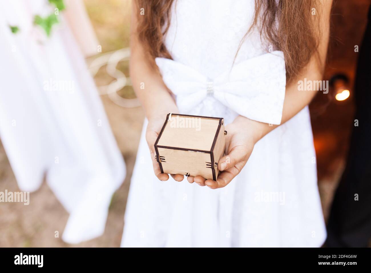 Mädchen hält eine Holzkiste in den Händen Stockfoto