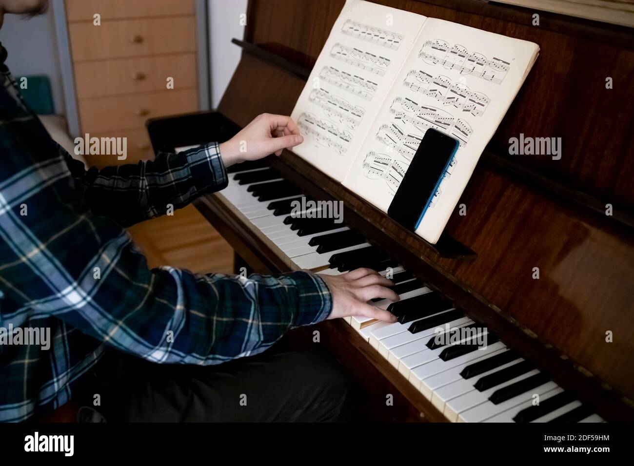Lehrer spielt Klavier während seiner Online-Lektion Stockfoto