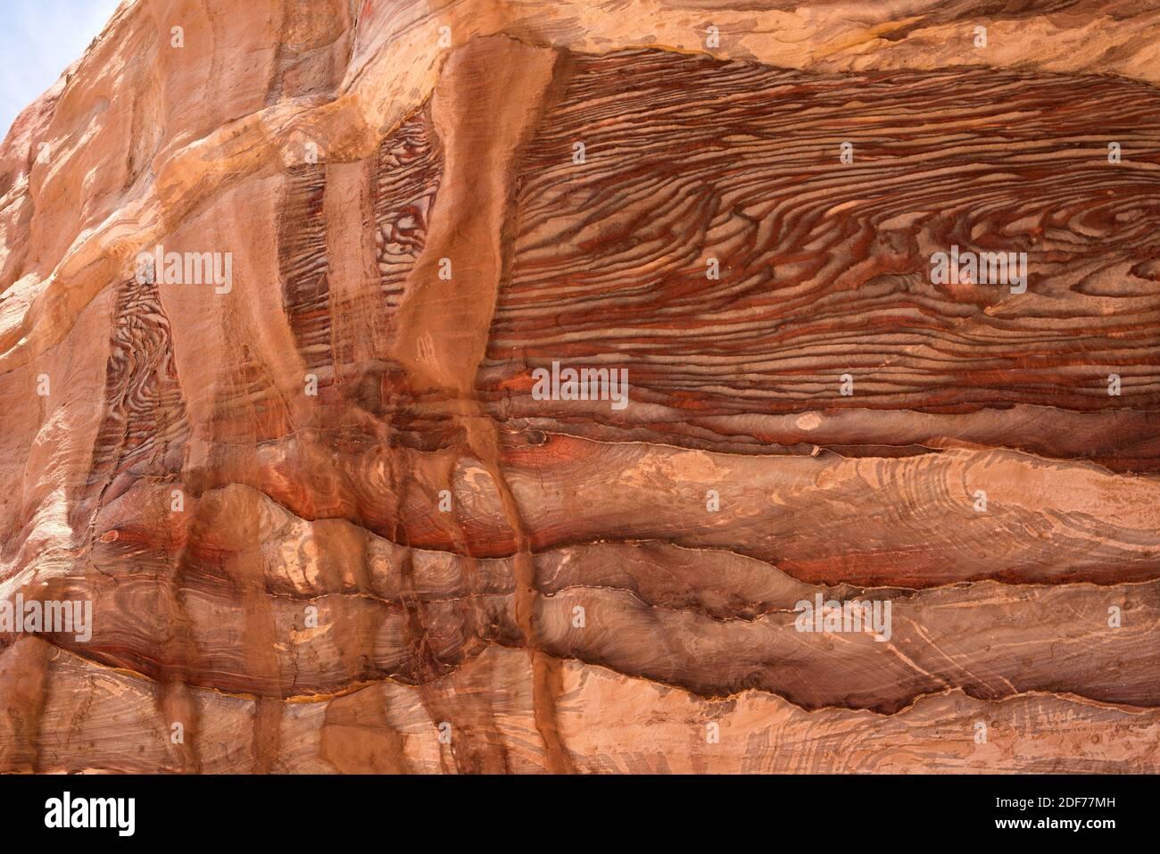 Mehrfarbiger Sandstein mit Kreuzschichtung und Liesegang-Bänderung. Dieses Foto wurde in Petra, Jordanien, aufgenommen. Stockfoto