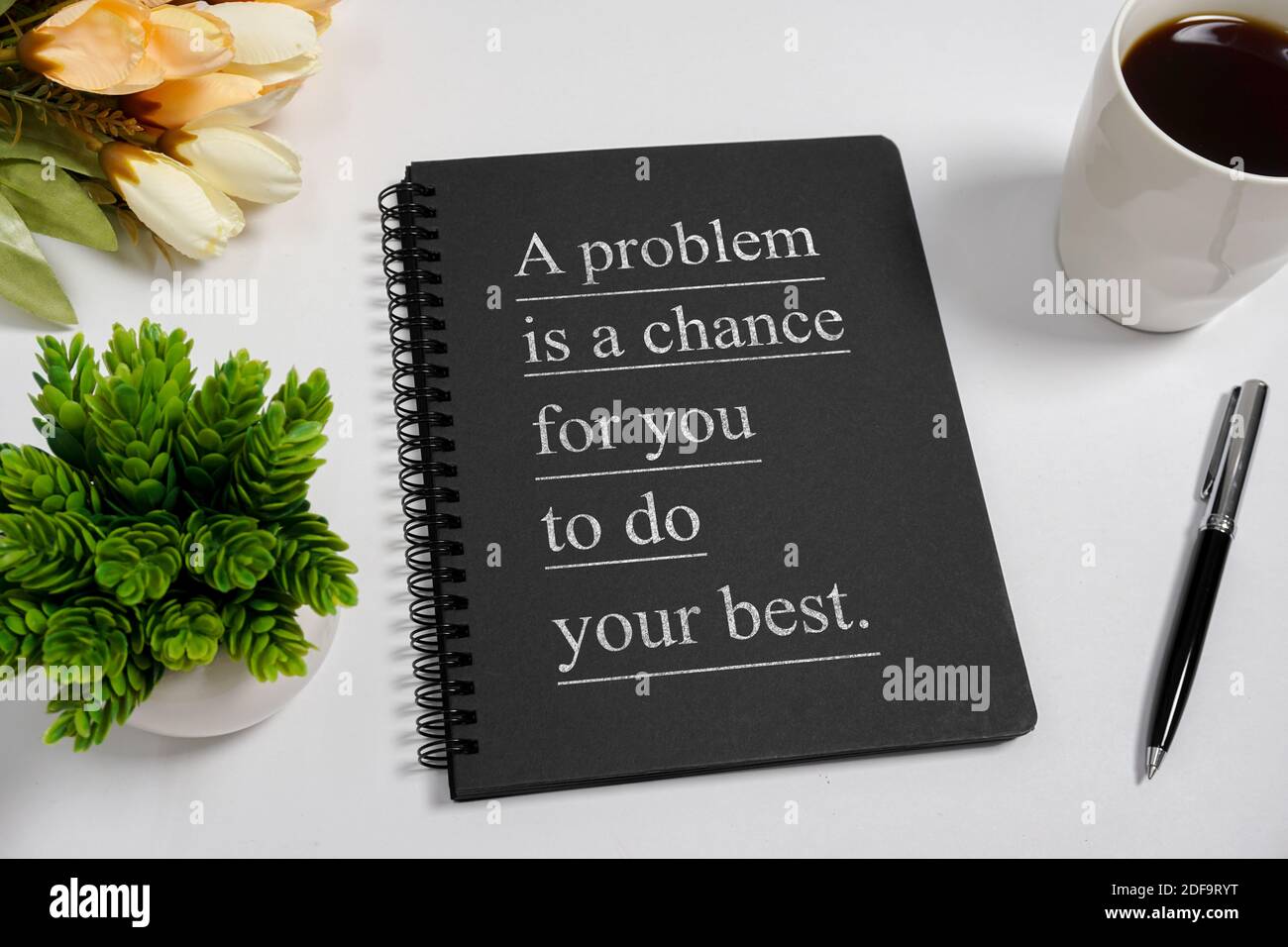 Notizbuch mit Weisheitszitat und Kaffeetasse auf weißem Hintergrund. Stockfoto