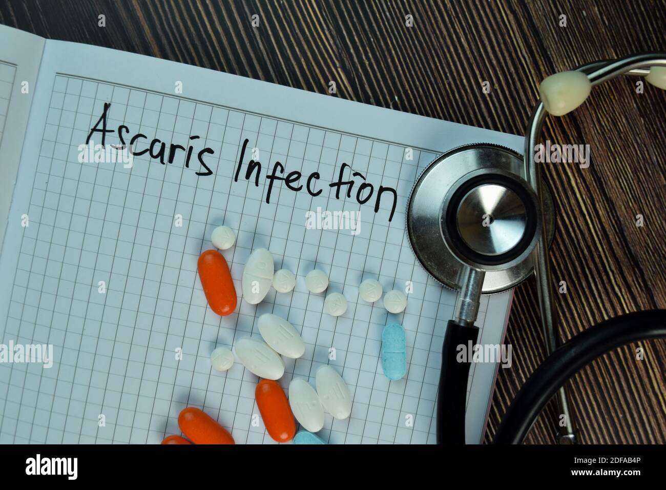 Ascaris Infektion Schreiben Sie auf ein Buch isoliert auf Holztisch. Medizinisches oder medizinisches Konzept Stockfoto