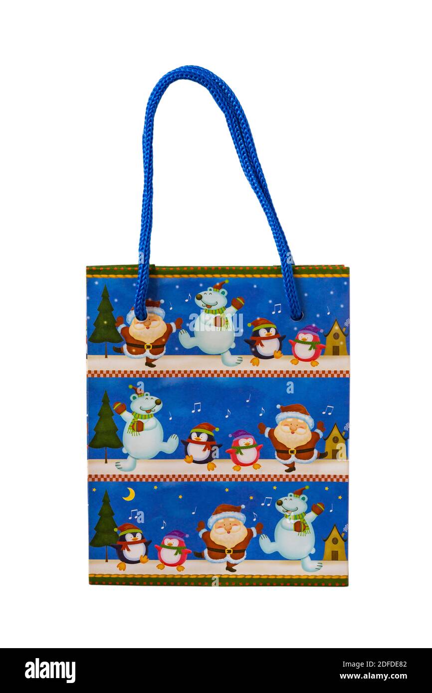 Weihnachts-Geschenktasche mit Weihnachtsfiguren auf isoliert auf weiß Hintergrund Stockfoto