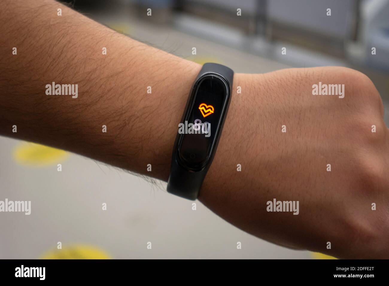 Nahaufnahme der schwarzen Smartwatch mit hoher Herzfrequenz pro Minute am Handgelenk eines Athleten Stockfoto