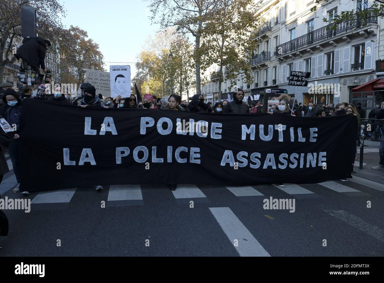 Demonstranten halten ein Transparent mit der Aufschrift "Polizeiverstümmelung, Polizeikills" während einer Demonstration gegen das neu verabschiedete umstrittene globale Sicherheitsgesetz in Paris, Die vom französischen Parlament verabschiedete globale Sicherheitsgesetzgebung zielt darauf ab, die Verbreitung von Fotos zu verbieten, in denen Polizisten und Gendarmen auf eine Weise identifiziert werden können, die ihr Image schädigt. Paris, Frankreich, 28/11/2020 Foto von Alfred Yaghobzadeh/ABACAPRESS;COM Stockfoto