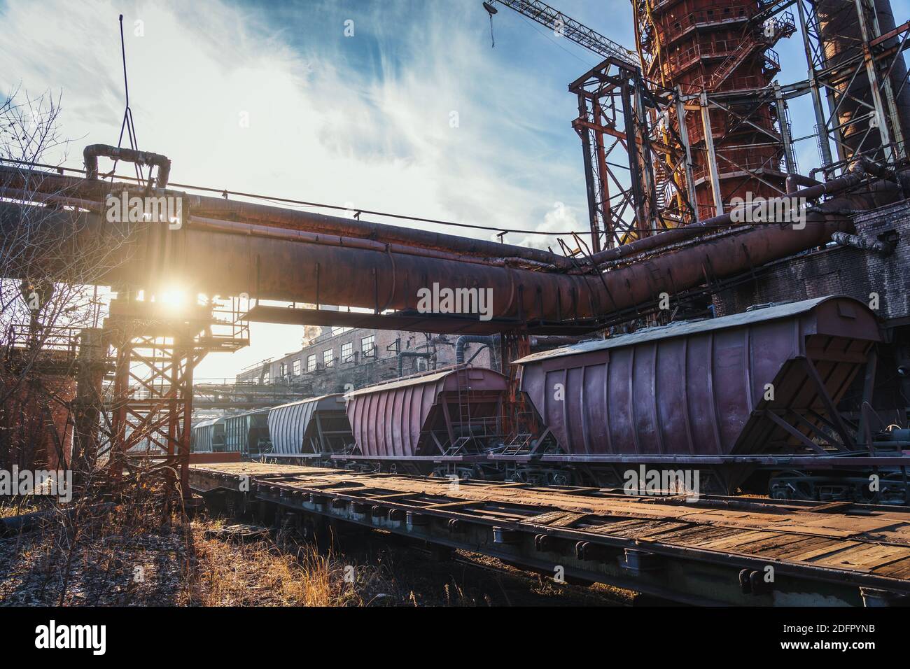 Hochofen von metallurgischen Anlagen oder Chemiefabrik mit industriellen Eisenbahn- und Güterwagen. Stockfoto