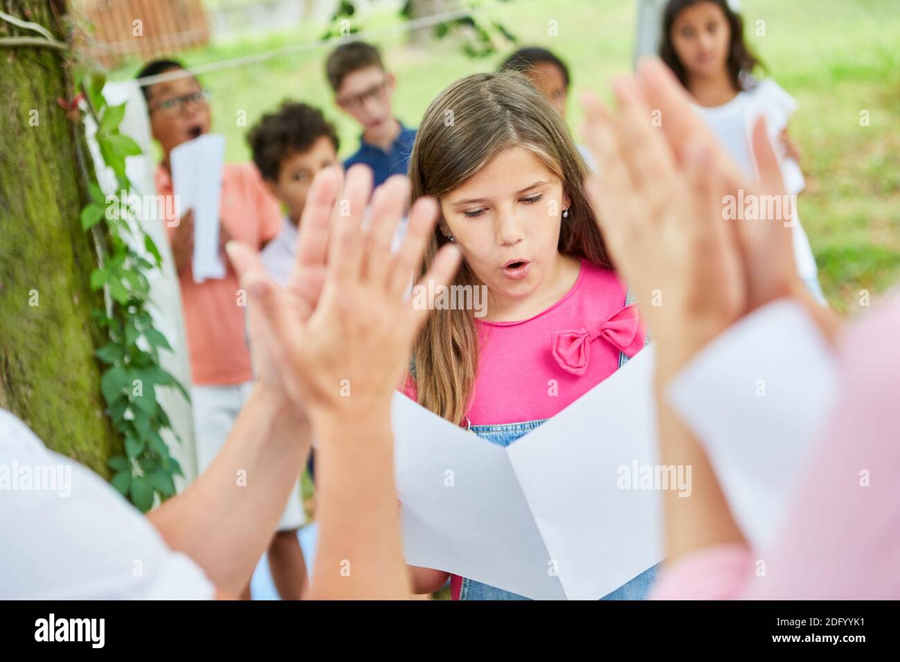 Das Publikum applaudiert Mädchen, die im Sommer solo auf einer Talentshow singen Lager Stockfoto