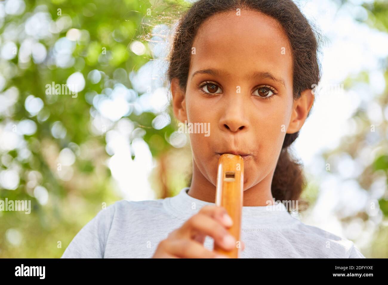 Mädchen übt Flötenspiel im Musikunterricht im Sommer Camp oder Sommercamp Stockfoto