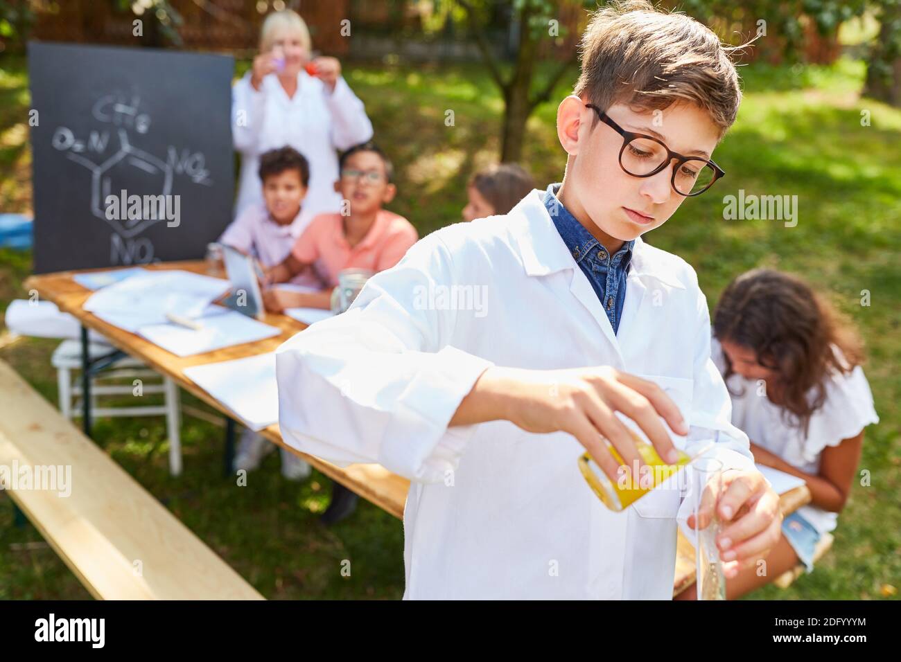 Junge in der Sommerschule Unterricht Chemie-Kurs macht ein Experiment Stockfoto