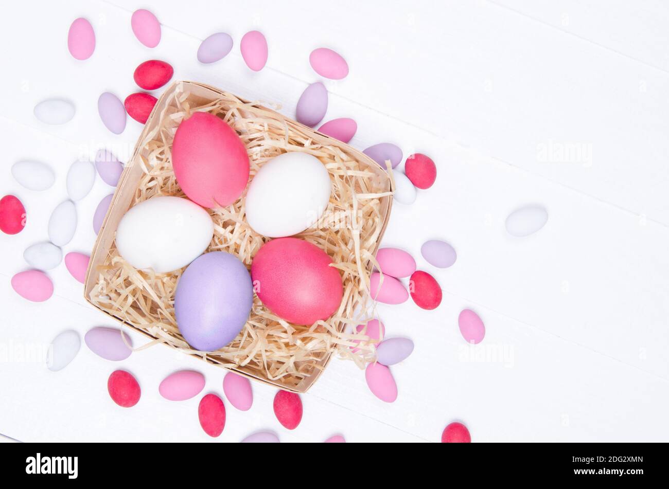 Ostereier im Nest auf weißem Holzhintergrund Stockfoto