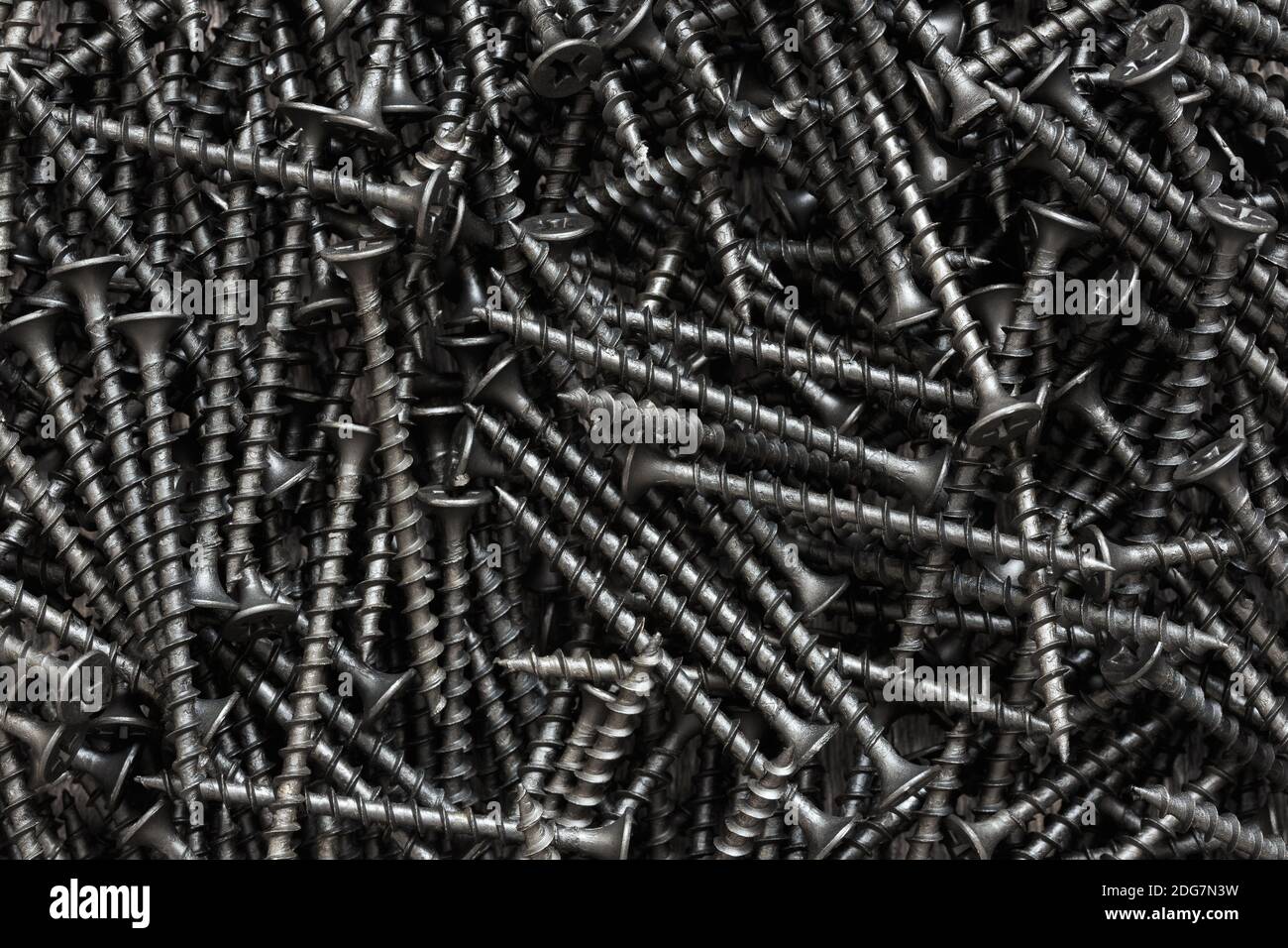 Stahl schwarz selbstschneidende Schrauben Nahaufnahme, industriellen Hintergrund. Stockfoto
