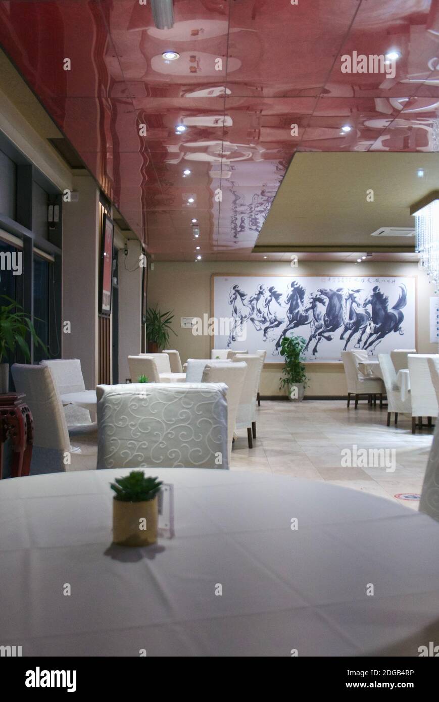 Leeres chinesisches Restaurant mit weißen Stühlen und Tischdecken. Geschäftsmangel während Tier 2 Covid19-Einschränkungen. Jun Ming Xuan, Colindale, London. Stockfoto
