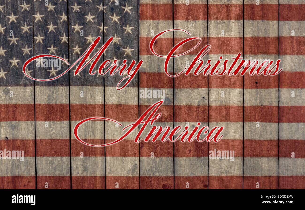 Merry Christmas America gemalt auf einem Vintage amerikanischen Flagge gemalt Auf der Seite einer Scheune Stockfoto