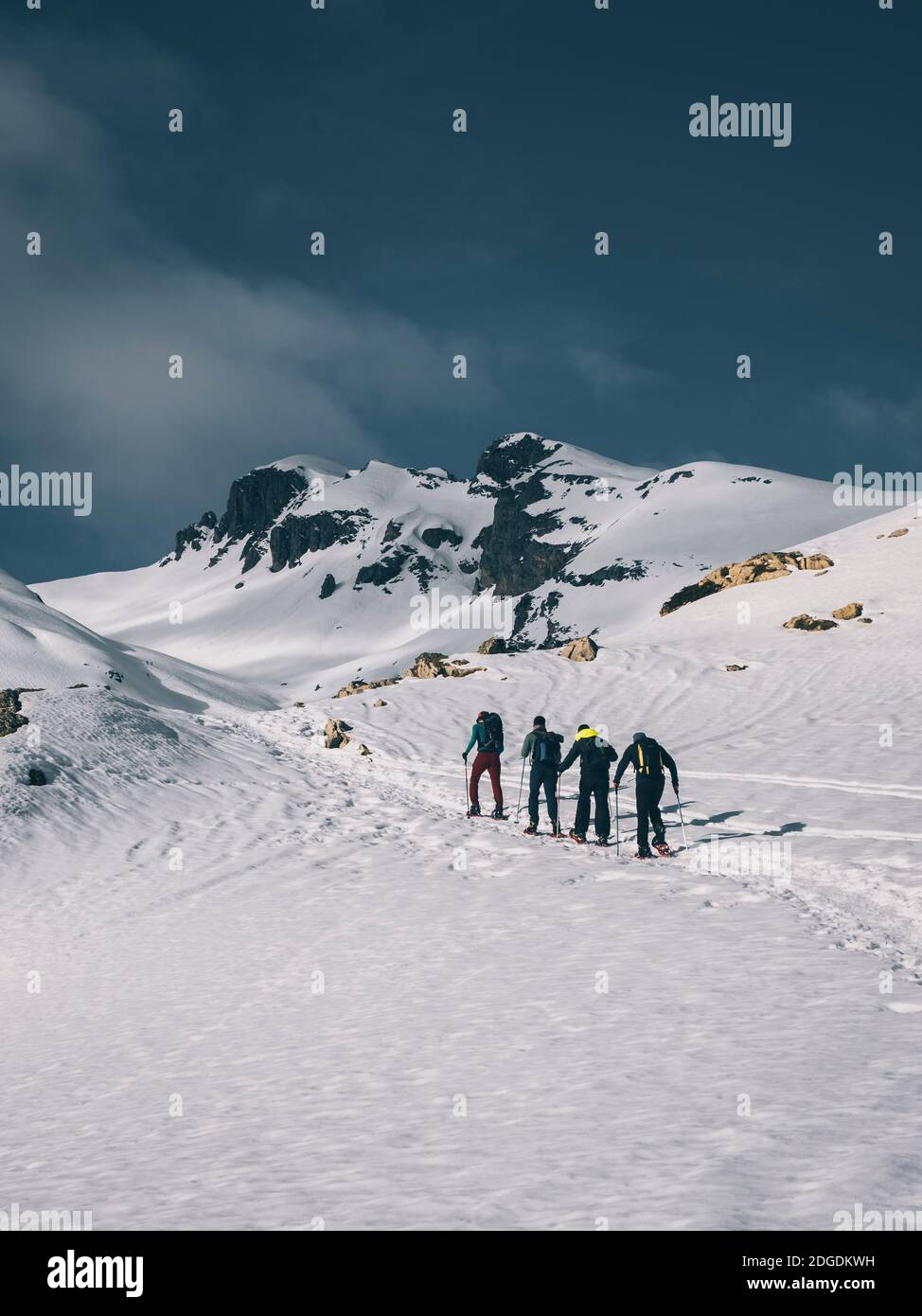 Eine Gruppe von männlichen Wanderern auf Schneeschuhen Richtung eines Berggipfels gegen schneebedeckte Berge, Portalet malerischen Pass zwischen Frankreich und Spanien Stockfoto