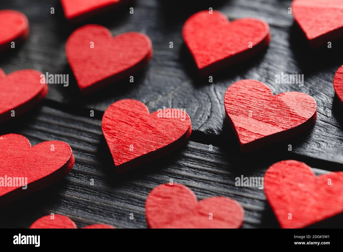 Schöne Valentinstag Hintergrund mit Holz roten Herzen auf schwarz Hintergrund Stockfoto