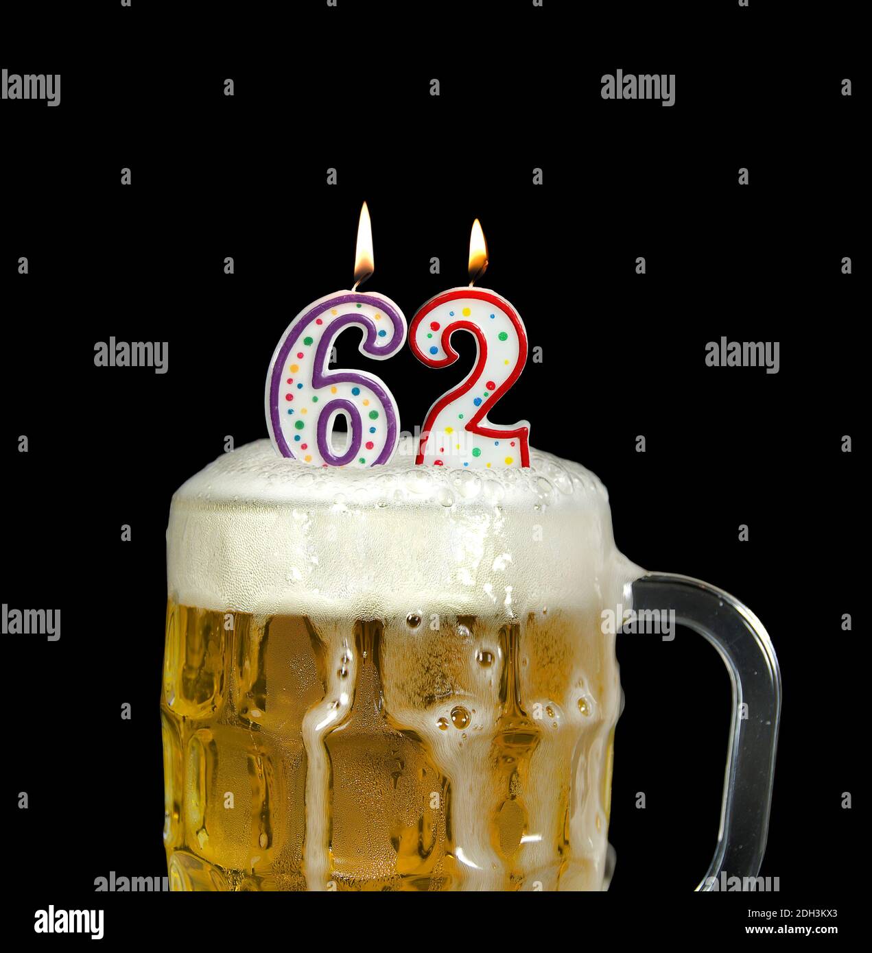 Angezündete Nummernkerzen im Bierkrug zum 62. Geburtstag isoliert Auf Schwarz Stockfoto