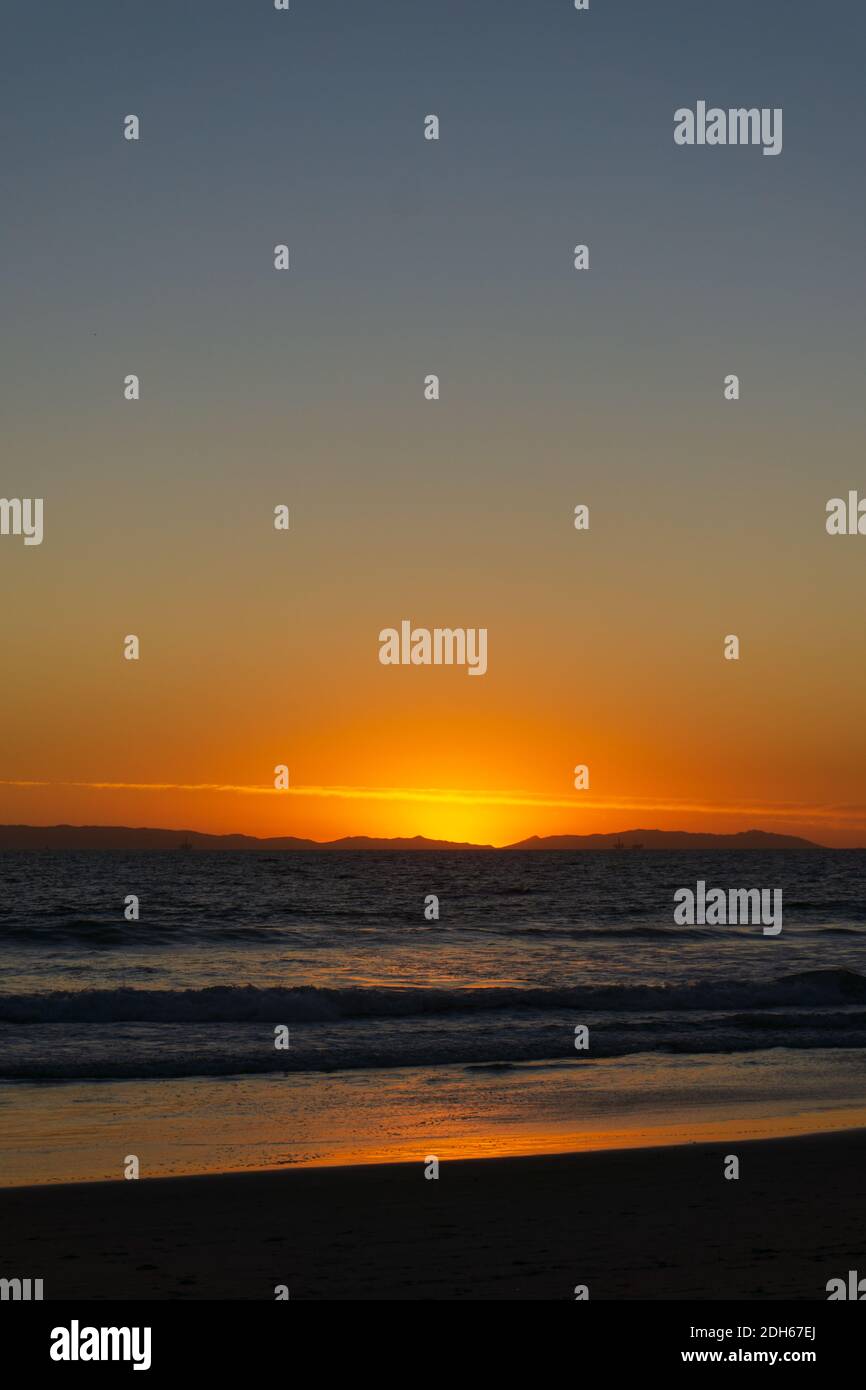 Sonnenuntergang am Strand in Südkalifornien mit Blick auf die Silhouette Von Catalina Island in der Ferne Stockfoto