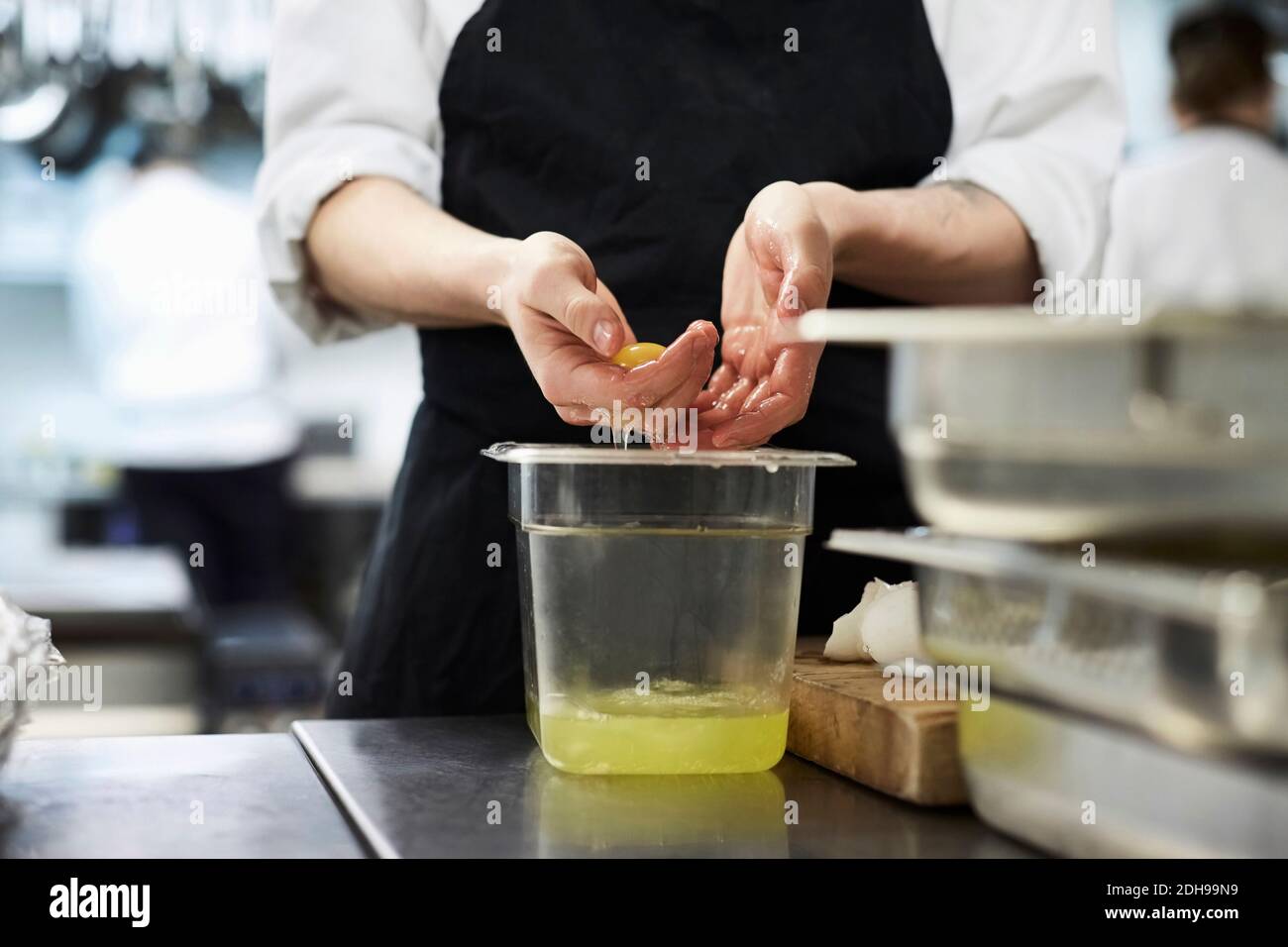 Mittelteil des Küchenchefs, der Eigelb von Weiß im Handel trennt Küche Stockfoto