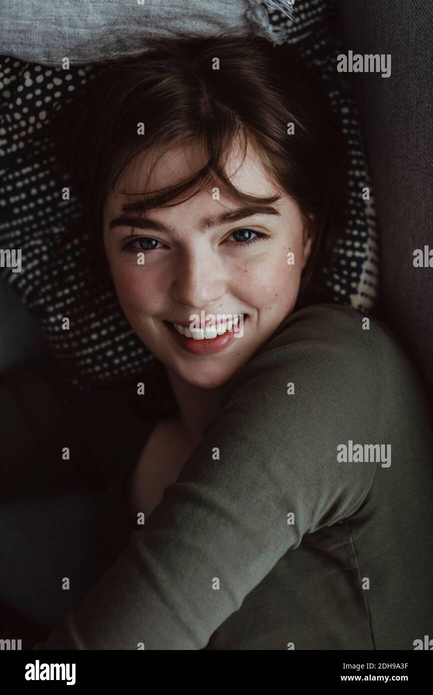 Porträt der lächelnde Frau auf sofa Stockfoto