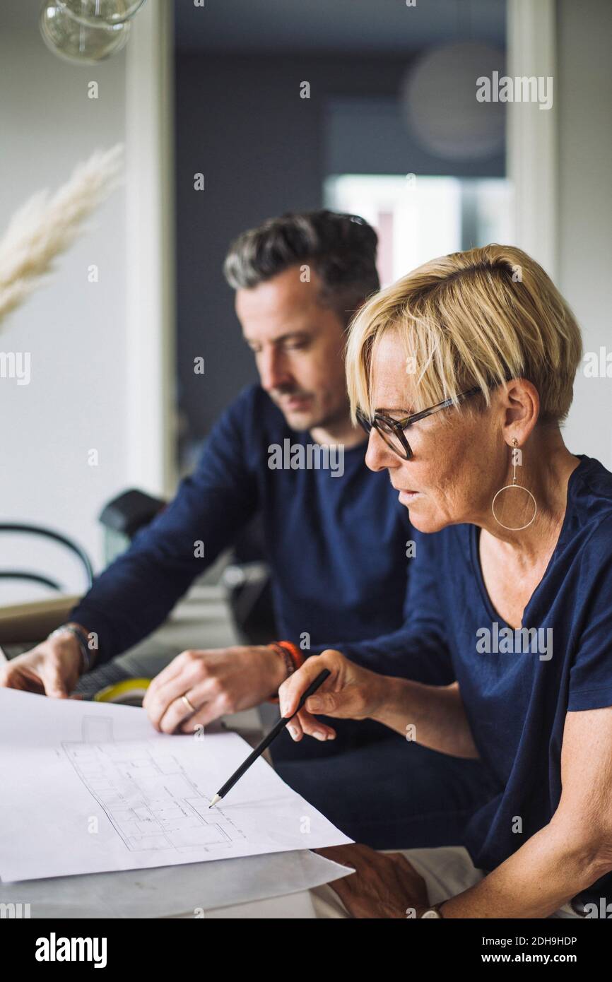 Frau und Mann diskutieren Blaupause arbeiten zu Hause Stockfoto