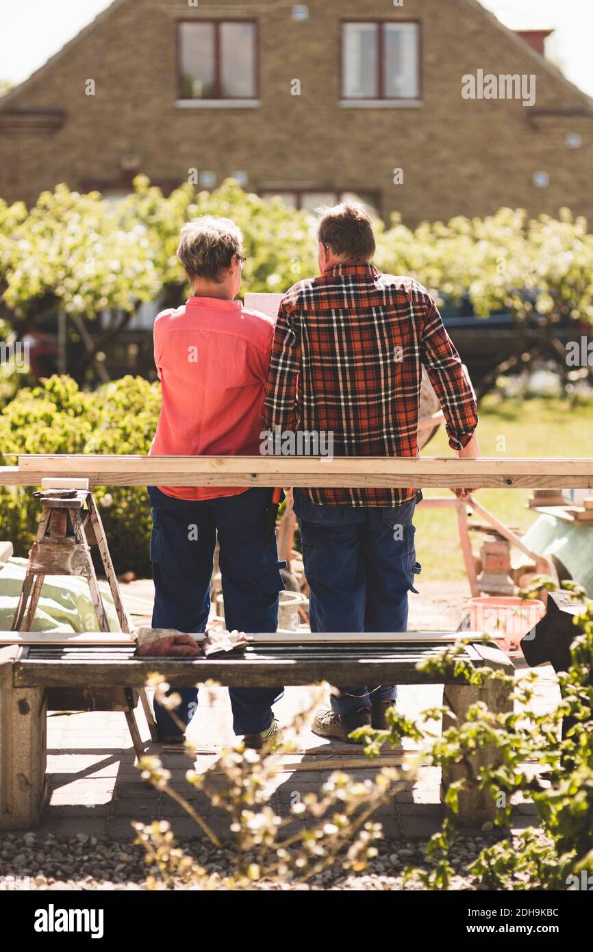 Rückansicht des älteren Ehepaares, das an der Holzdiele steht Hof Stockfoto