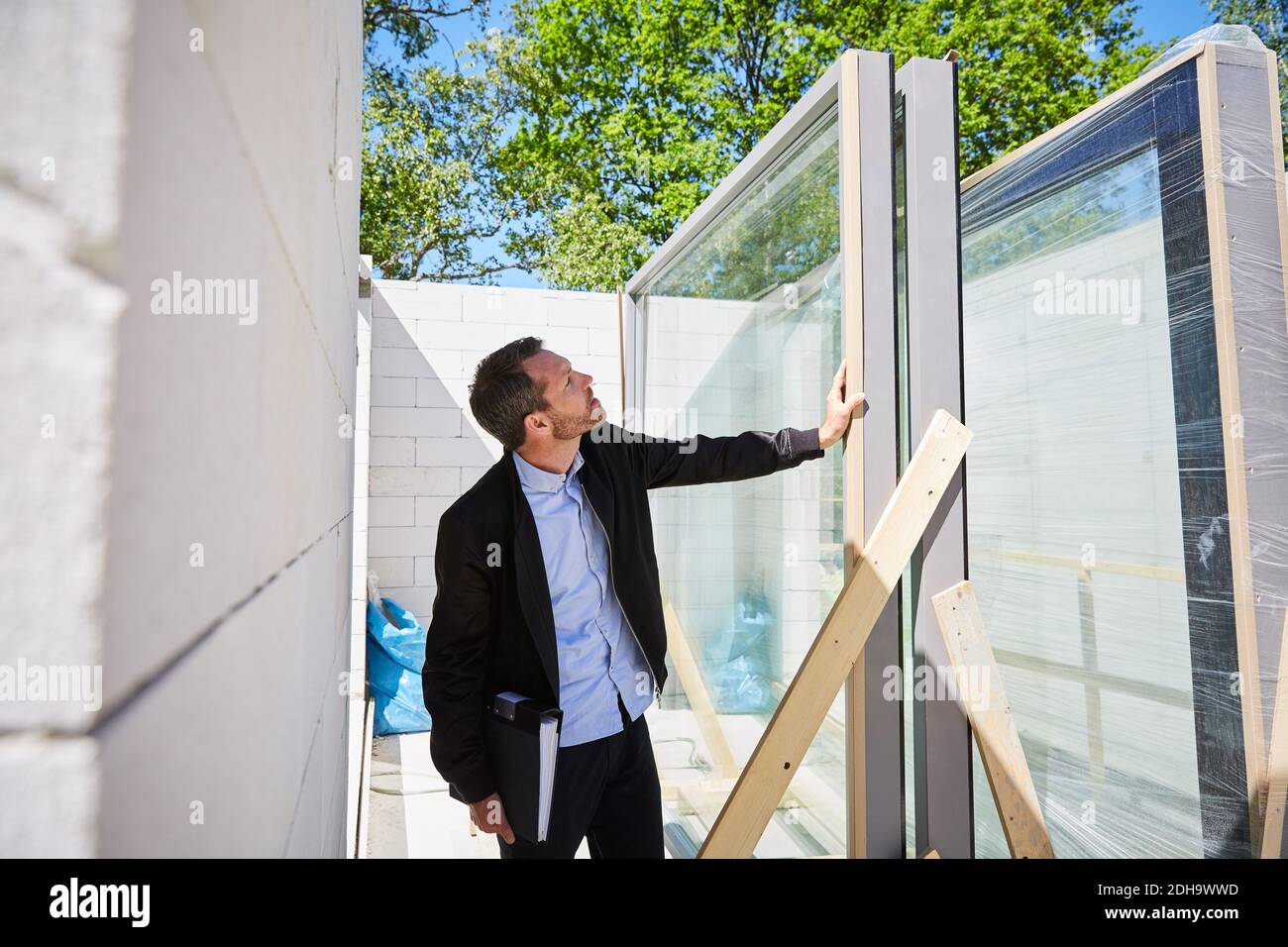 Architekt mit Datei Analyse auf der Baustelle an sonnigen Tag Stockfoto