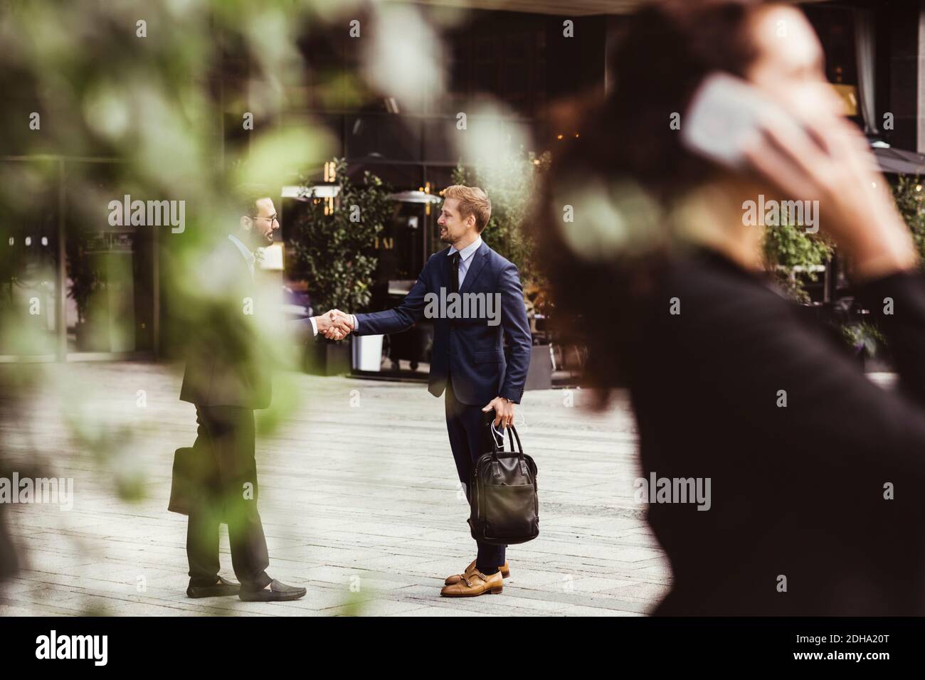 Männliche Unternehmer schüttelt die Hände, während sie im Freien stehen Stockfoto