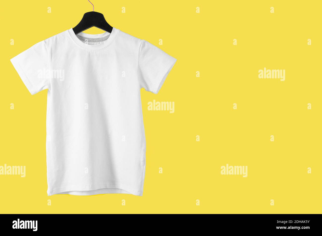 Weißes T-Shirt gegen leuchtenden gelben Hintergrund, Farbe des Jahres 2021 Stockfoto