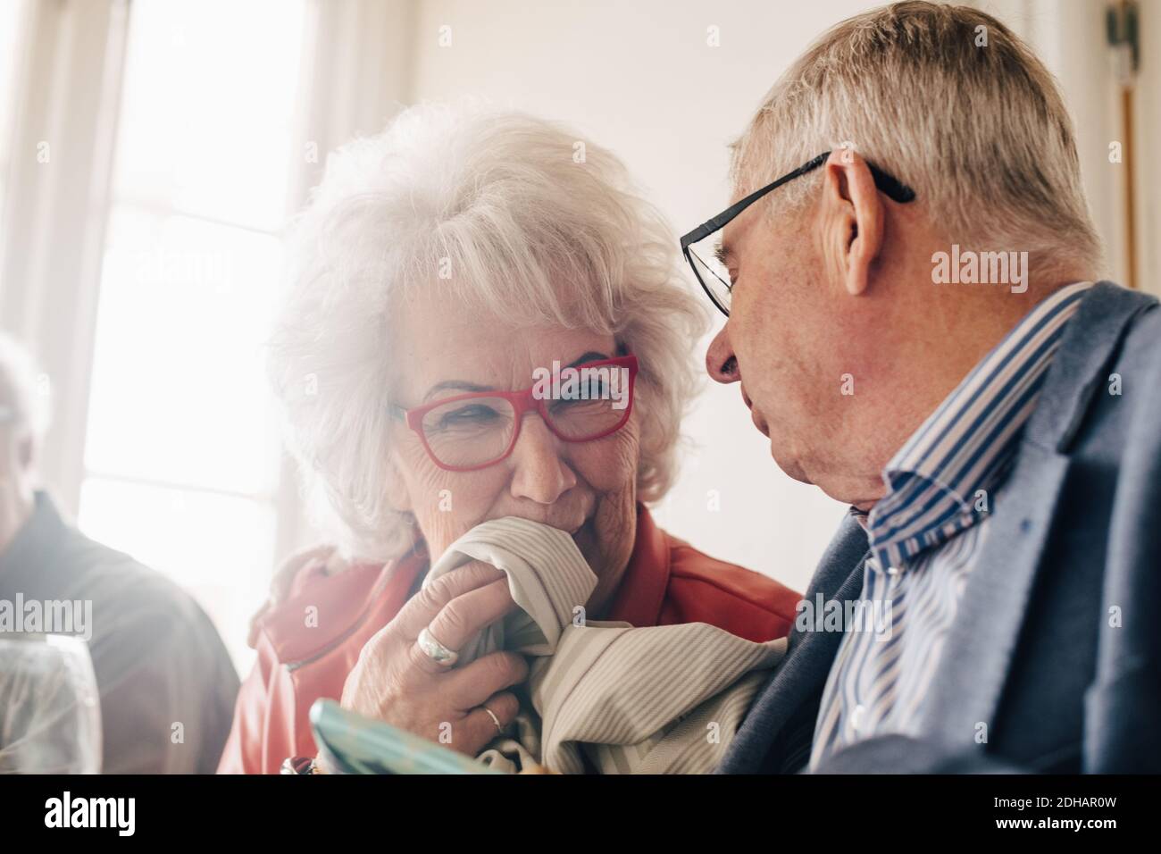 Ältere Frau im Restaurant im Gespräch mit einem Freund Stockfoto