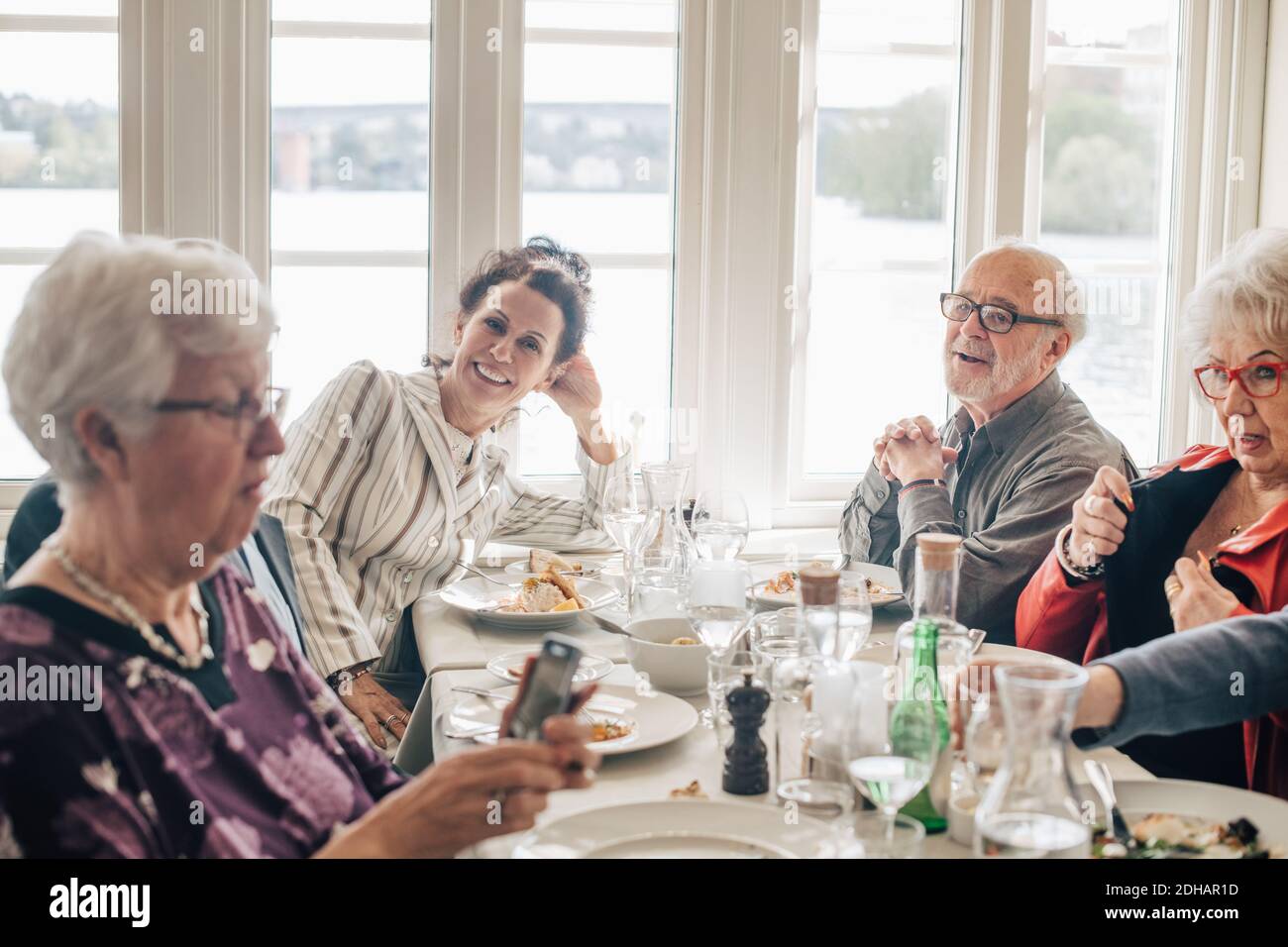 Ältere Freunde sprechen beim Sitzen im Restaurant Stockfoto