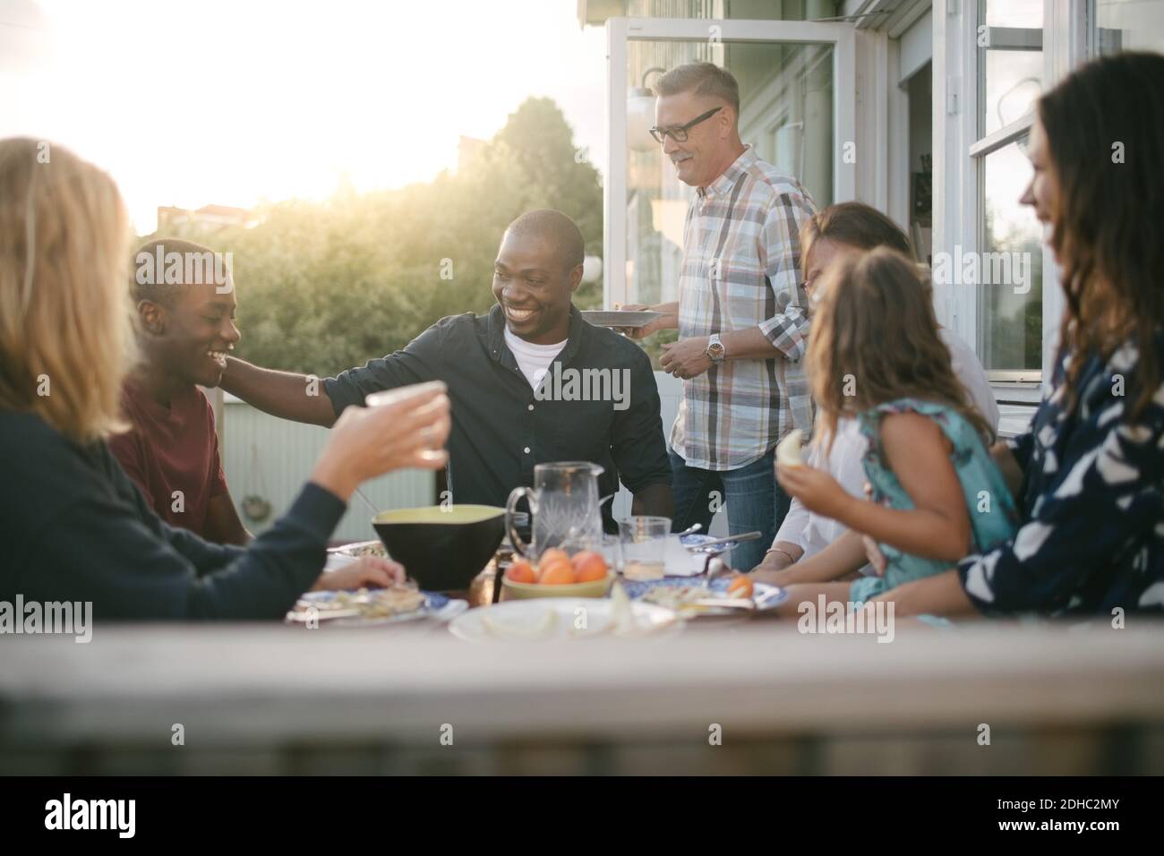 Fröhliche Multi-Generation-Familie genießen Mittagessen auf der Veranda Stockfoto