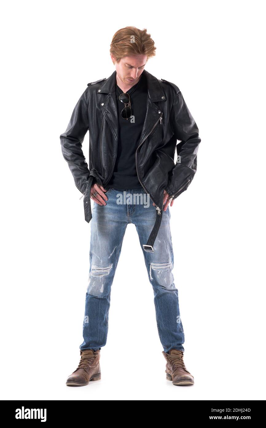 Stylischer junger Mann in Biker- oder Rocker-Kleidung auf der Suche nach verlorenem Gegenstand in Jeans-Taschen. Ganzkörperlänge isoliert auf weißem Hintergrund. Stockfoto Stylischer junger Mann in Biker- oder Rocker-Kleidung auf der Suche nach verlorenem Gegenstand in Jeans-Taschen. Ganzkörperlänge isoliert auf weißem Hintergrund. Stockfoto