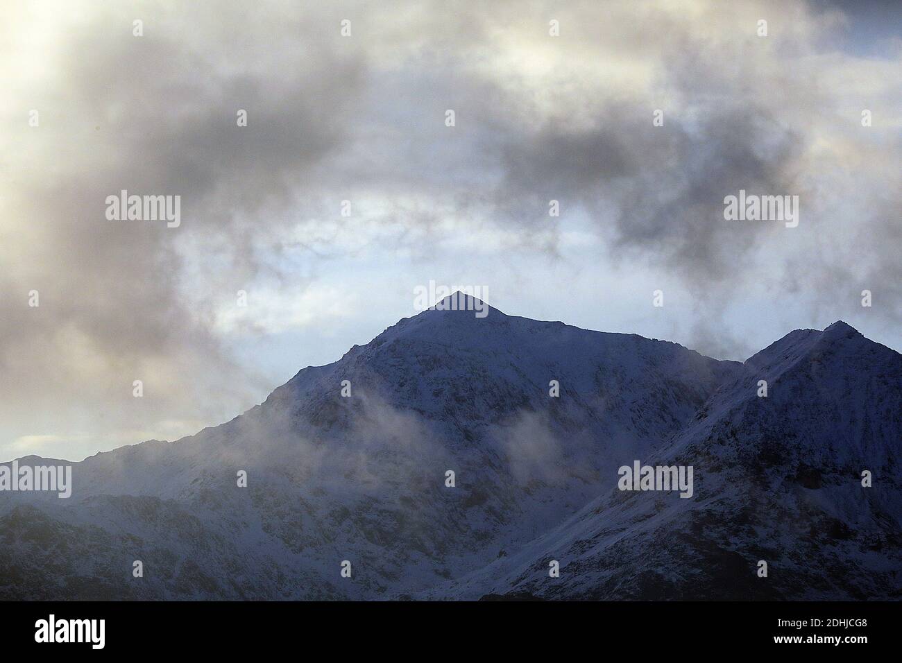 Sonnenuntergang über dem Snowdon-Hufeisen, der jüngsten Schneefall zeigt. Wales. Bild aufgenommen am 5. Dezember 2020 Stockfoto