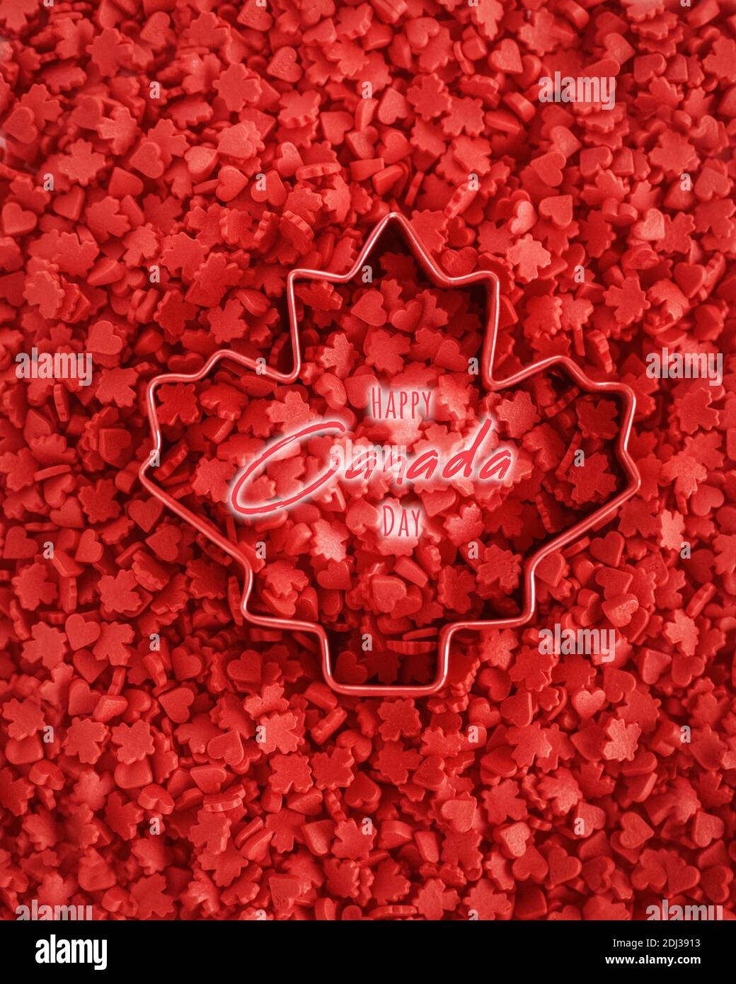 Happy Canada Day Karte mit Text. Lebendige rot bunte kleine kleine kleine Süßigkeiten Ahornblätter und Herzen. Ausstechform in Form von Ahornblatt Stockfoto