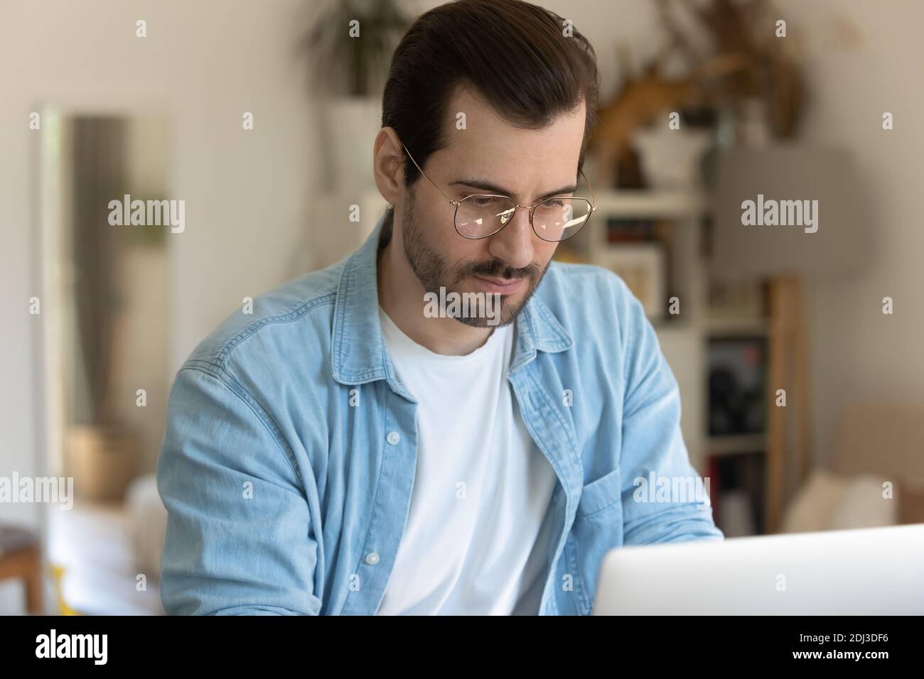 Nahaufnahme ernsthaft fokussierten Mann trägt Brille mit Laptop, arbeiten Stockfoto