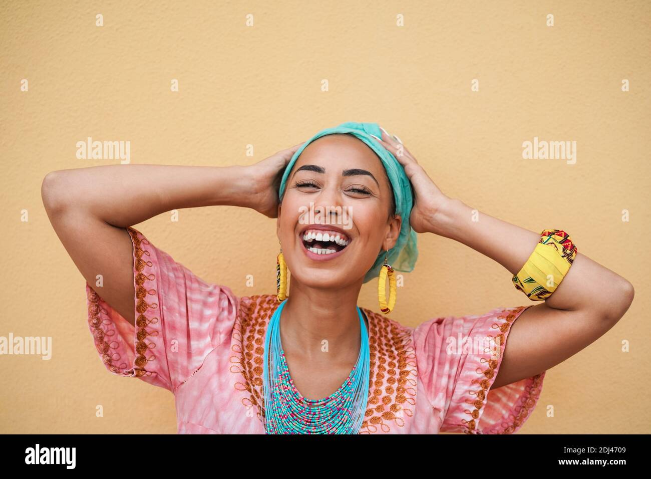 Porträt einer glücklichen schwarzen jungen Frau in traditionellen afrikanischen Kleid - Fokus auf Gesicht Stockfoto