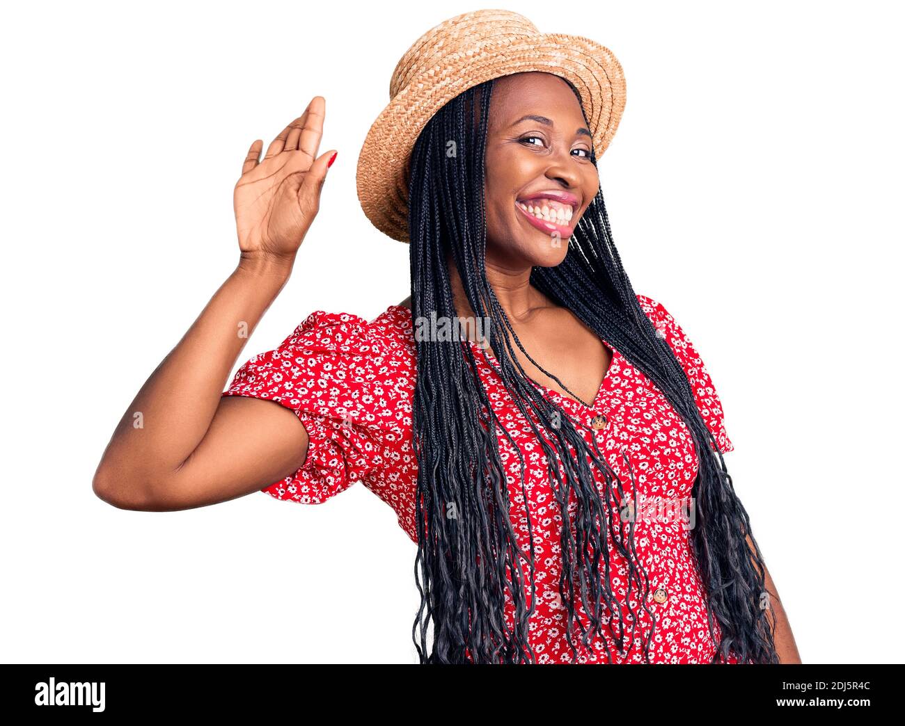 Junge afroamerikanische Frau trägt Sommerhut waiving sagen Hallo glücklich und lächelnd, freundliche Willkommensgeste Stockfoto