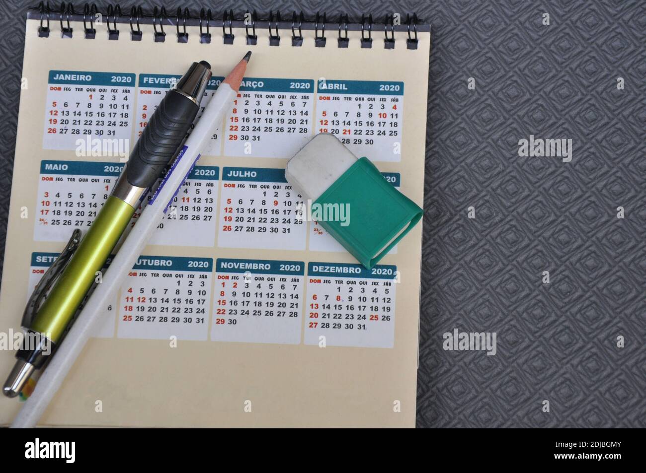 Kalender des Jahres 2020 mit Bleistift, Stift und Radierer im Negativraum auf schwarzem Hintergrund Stockfoto