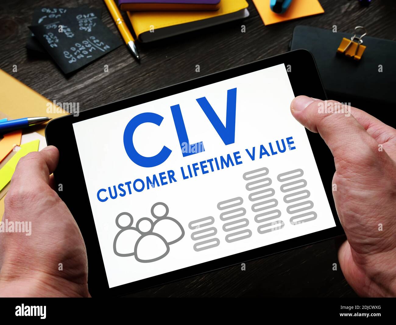 Man liest einen Customer Lifetime Value CLV-Bericht auf einem Tablet. Stockfoto