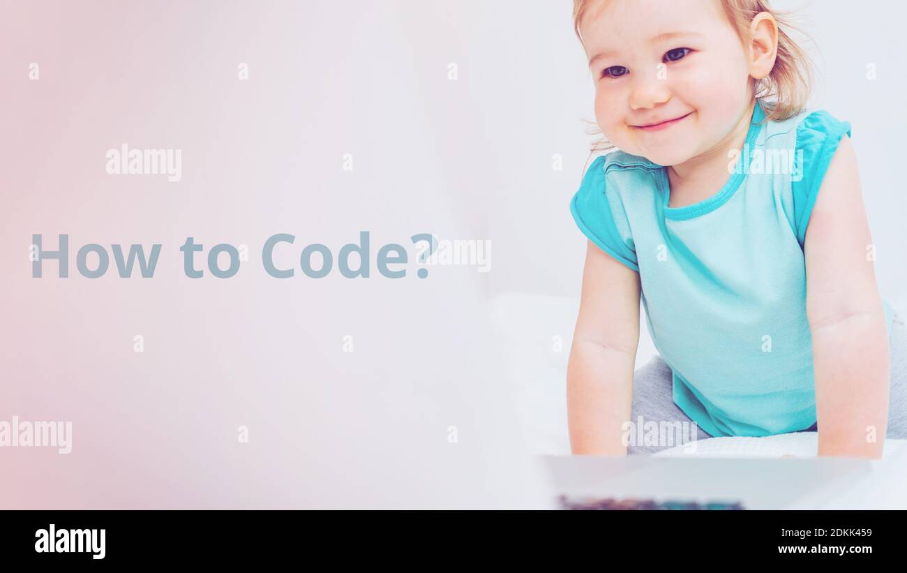 Wie kodiert man mit einem lächelnden Kind an einem Laptop? Stockfoto