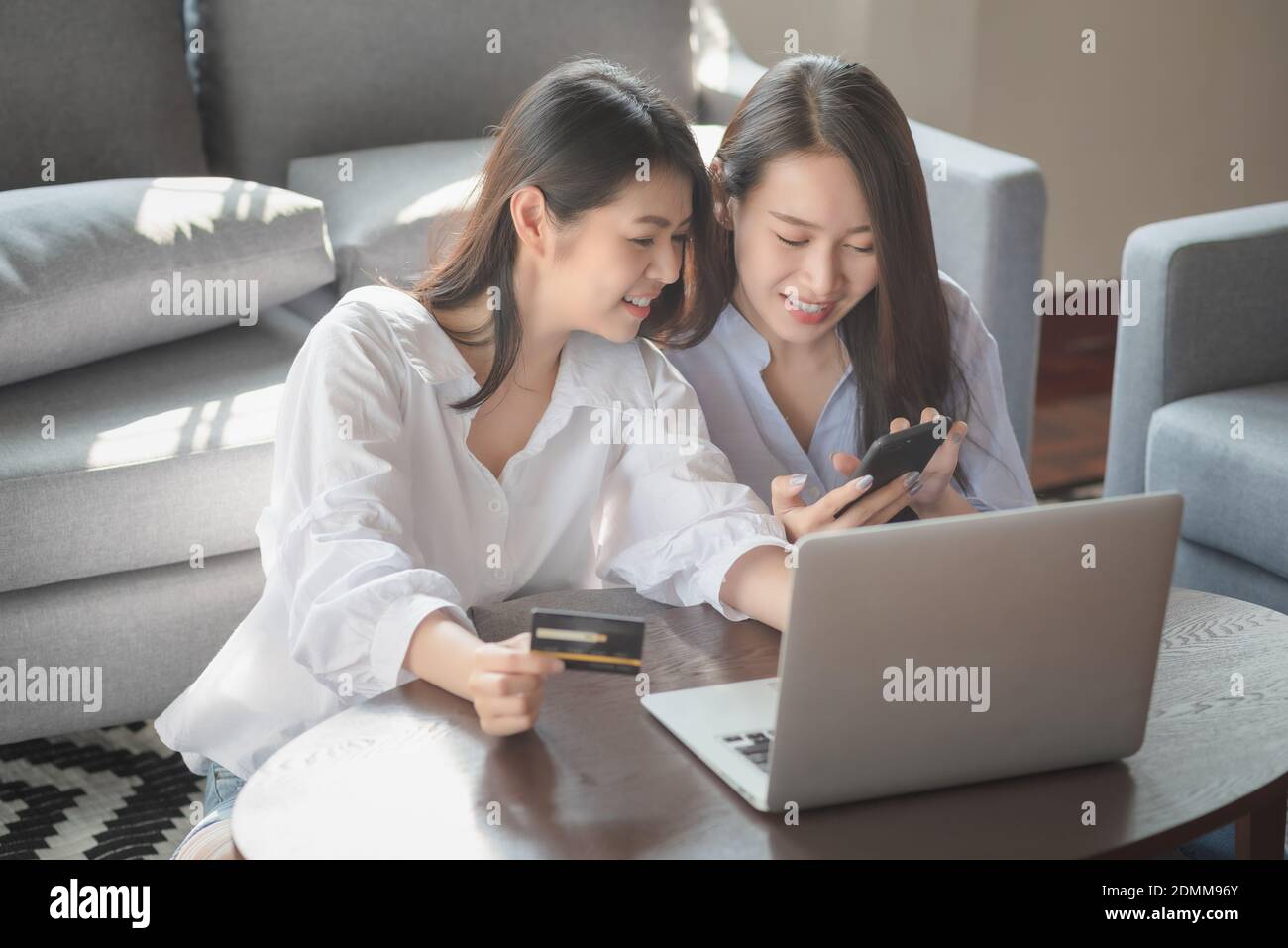 Zwei junge Frau verwenden Laptop-Computer zum Online-Shopping via internet während des Aufenthalts sicher zu Hause Stockfoto